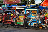 Riding the becak, the local cycle rickshaws in Malioboro street Yogyakarta. 